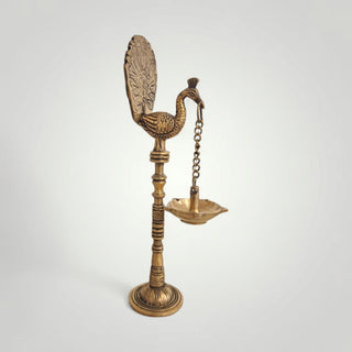 Brass peacock with hanging diya