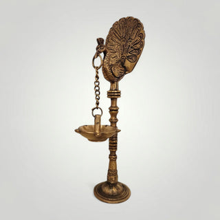 Brass peacock with hanging diya