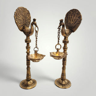 Brass peacock with hanging diya