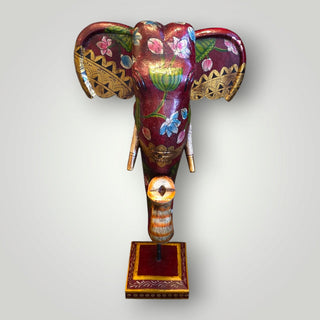Wooden deep red elephant trunk on stand