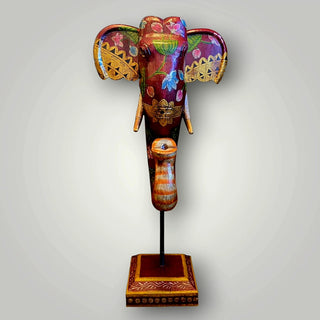 Wooden deep red elephant trunk on stand
