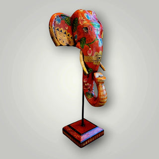 Wooden orange elephant trunk on stand
